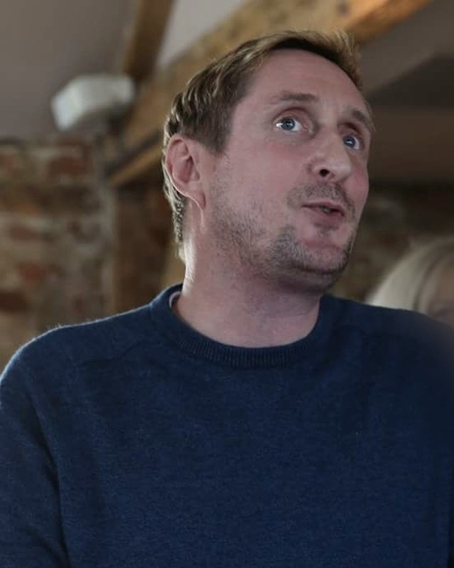 Mark Gather speaking, mid-sentence, in a converted barn room