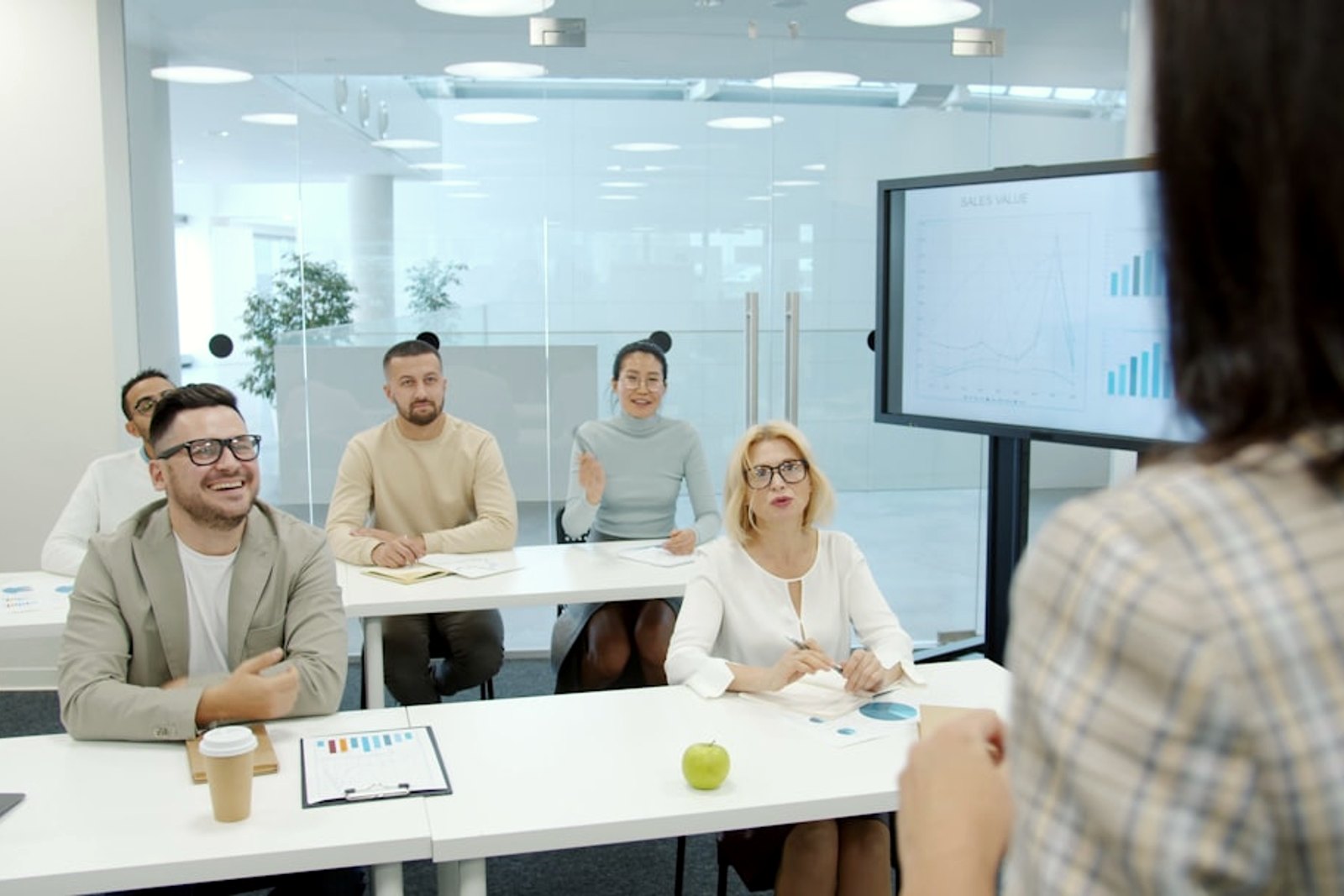 A professional speaking with confidence to a small group in a meeting